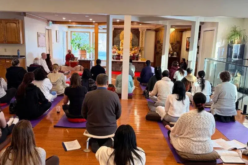Buddhist monk leading a loving-kindness meditation session with retreat participants at Mahamevnawa Buddha Meditation Centre Winnipeg